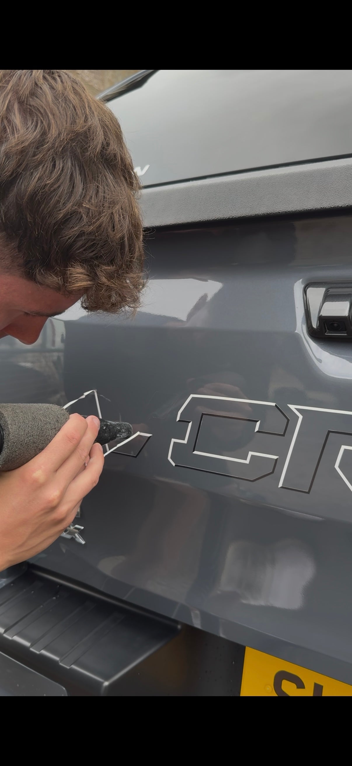 Technician removing vinyl sticker from vehicle in Perth, Scotland β professional decal and adhesive removal service