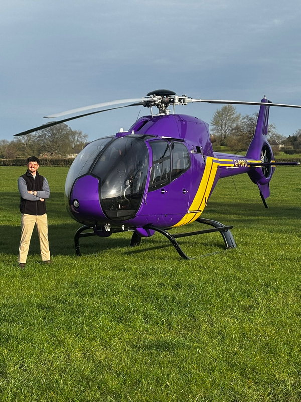 Student has detailed a helicopter and is pictured beside it after detailing for ultra high network individual  and his luxury vehicles,