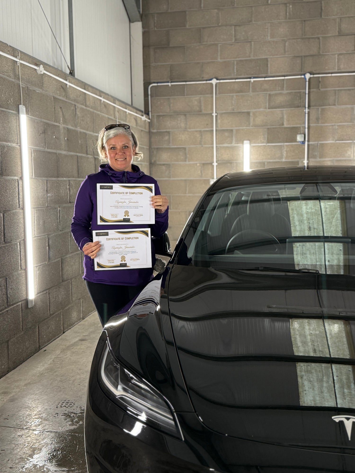 Student receiving a certificate after travelling from uk to Scotland to compete detailing training course